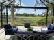 Relaxing lanai with golf course view and patio furniture at 3375 Osprey Ln, Port Charlotte, FL 33953