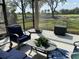 Covered lanai features comfortable seating and golf course views at 3375 Osprey Ln, Port Charlotte, FL 33953
