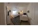 Bright bedroom with two beds and ceiling fan at 7580 Camminare Dr, Sarasota, FL 34238