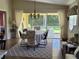 Dining room with a table, chairs, and access to a screened patio at 7580 Camminare Dr, Sarasota, FL 34238