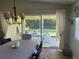View from dining room showing sliding doors to a screened patio at 7580 Camminare Dr, Sarasota, FL 34238