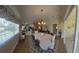 Spacious dining room with hardwood floors and view into kitchen at 7580 Camminare Dr, Sarasota, FL 34238