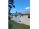 House exterior featuring a yellow-painted facade, white columns, and a lush lawn at 7580 Camminare Dr, Sarasota, FL 34238