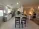 Modern kitchen with granite countertops and island seating at 7580 Camminare Dr, Sarasota, FL 34238