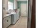 Laundry room with washer, dryer and built-in cabinets at 7580 Camminare Dr, Sarasota, FL 34238