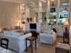 Bright living room showcasing a comfy seating arrangement and built-in shelving at 7580 Camminare Dr, Sarasota, FL 34238