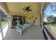 Relaxing screened porch with patio furniture and view of backyard at 7580 Camminare Dr, Sarasota, FL 34238