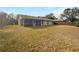 Spacious backyard featuring a screened-in porch, surrounded by a wood fence at 14315 Knoll Ridge Dr, Tampa, FL 33625