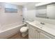 Clean bathroom with white fixtures, tiled walls, and a bathtub/shower combination at 14315 Knoll Ridge Dr, Tampa, FL 33625