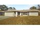 Charming single-story home features a stone facade, attached garage, and well-maintained lawn at 14315 Knoll Ridge Dr, Tampa, FL 33625