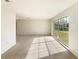 Open living room with large window offering plenty of natural light and serene views at 14315 Knoll Ridge Dr, Tampa, FL 33625
