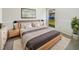 A spacious bedroom featuring a large bed, neutral tones, carpet floors, and a bright window at 14315 Knoll Ridge Dr, Tampa, FL 33625