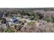 Aerial view of houses and neighborhood with a lake in the background at 15727 Cedar Elm Ter, Land O Lakes, FL 34638