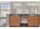 Double vanity bathroom with dark countertop and wood cabinets at 15727 Cedar Elm Ter, Land O Lakes, FL 34638