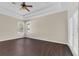 Large bedroom with dark wood floors and multiple windows at 15727 Cedar Elm Ter, Land O Lakes, FL 34638