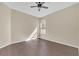 Well lit bedroom with dark wood floors and ceiling fan at 15727 Cedar Elm Ter, Land O Lakes, FL 34638