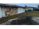 Attached garage with stone exterior and double doors at 23102 Maclellan Ave, Port Charlotte, FL 33980