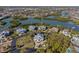 Drone view showcasing waterfront property and surrounding houses at 7092 Baypine Ln, Englewood, FL 34224