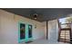 Basement access with teal doors and wood stairs at 7092 Baypine Ln, Englewood, FL 34224