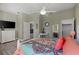 Bedroom with white dresser, large TV, and colorful bedding at 7092 Baypine Ln, Englewood, FL 34224