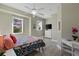 Bedroom with white dresser, ceiling fan and colorful bedding at 7092 Baypine Ln, Englewood, FL 34224