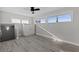 Bedroom with gray walls, ceiling fan, and wood-look floors at 7092 Baypine Ln, Englewood, FL 34224