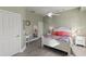 Bedroom with white door, ceiling fan and colorful bedding at 7092 Baypine Ln, Englewood, FL 34224
