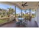 Relaxing deck with table and chairs, overlooking lush landscape at 7092 Baypine Ln, Englewood, FL 34224