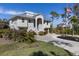 Two-story house with attached garage and landscaped front yard at 7092 Baypine Ln, Englewood, FL 34224
