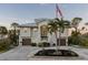 Two-story house with attached garage and palm trees in the front yard at 7092 Baypine Ln, Englewood, FL 34224