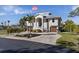 Two-story house with attached garage, palm trees and circular driveway at 7092 Baypine Ln, Englewood, FL 34224
