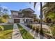 Two-story home with driveway, landscaping, and fenced backyard at 7092 Baypine Ln, Englewood, FL 34224
