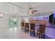 Relax in this game room with a bar, seating, and coastal decor at 7092 Baypine Ln, Englewood, FL 34224