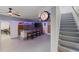Game room with bar, seating, and stairs nearby at 7092 Baypine Ln, Englewood, FL 34224