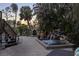 Private hot tub with waterfall feature and outdoor seating at 7092 Baypine Ln, Englewood, FL 34224