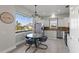 Modern kitchen with white cabinets, stainless steel appliances, and a breakfast nook at 7092 Baypine Ln, Englewood, FL 34224