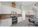 Well-equipped kitchen featuring stainless steel appliances and white cabinetry at 7092 Baypine Ln, Englewood, FL 34224