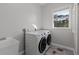 Laundry room with washer, dryer, and utility sink at 7092 Baypine Ln, Englewood, FL 34224