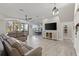 Spacious living area with hardwood floors, sectional sofa, and views to kitchen and entry at 7092 Baypine Ln, Englewood, FL 34224