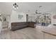 Spacious living room featuring hardwood floors, a large sectional sofa, and an open floor plan at 7092 Baypine Ln, Englewood, FL 34224