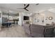 Open concept living room with kitchen, dining area, and comfortable seating at 7092 Baypine Ln, Englewood, FL 34224