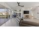 Open living room with a view of the kitchen, dining, and balcony at 7092 Baypine Ln, Englewood, FL 34224