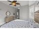 Main bedroom with king bed, dresser and access to bathroom at 7092 Baypine Ln, Englewood, FL 34224