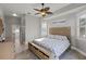 Main bedroom with king bed and private access to bathroom at 7092 Baypine Ln, Englewood, FL 34224