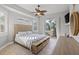 Main bedroom with king bed, private balcony, and dresser at 7092 Baypine Ln, Englewood, FL 34224