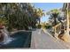 Tranquil pool area with waterfall feature and patio at 7092 Baypine Ln, Englewood, FL 34224