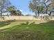Landscaped backyard with grassy area and a tall wall for privacy at 3473 Parkridge Cir # 17-101, Sarasota, FL 34243