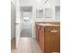 Bathroom with wood cabinets, a large mirror, and view of bedroom at 3473 Parkridge Cir # 17-101, Sarasota, FL 34243