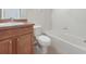 Clean bathroom with a tub, toilet, and wood vanity at 3473 Parkridge Cir # 17-101, Sarasota, FL 34243