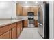 Neat kitchen featuring stainless steel appliances and wood cabinets at 3473 Parkridge Cir # 17-101, Sarasota, FL 34243